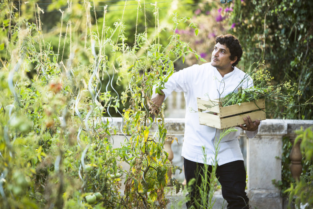 Mauro Colagreco in his garden picking fresh produce